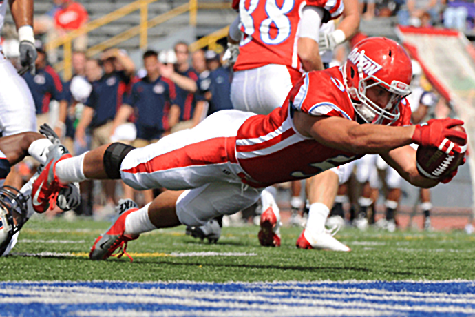 Dayton's Taylor Harris returned from a opening-weekend injury to rush for 107 yards and two touchdowns in a 20-14 home-opening victory against Robert Morris, Saturday.